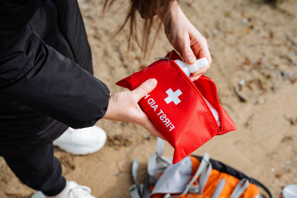 istock A woman is on the beach holding a red first aid kit 2167432500