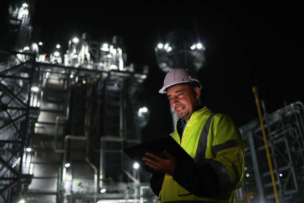 istock At a power plant, a senior engineer wearing a safety uniform is using a digital tablet during the night shift. This power plant might be involved in producing electricity from coal, oil or natural gas, or producing other products like gasoline or plastics 2167433313
