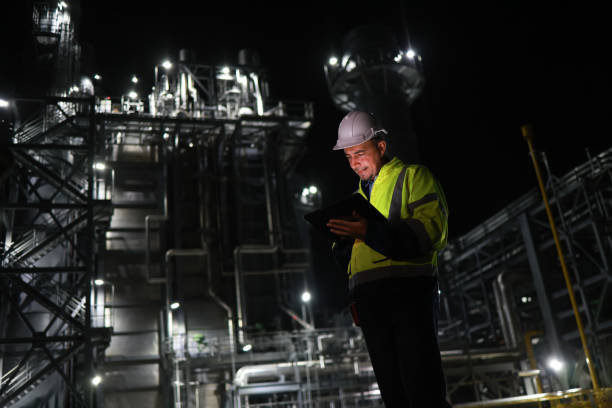 istock At a power plant, a senior engineer wearing a safety uniform is using a digital tablet during the night shift. This power plant might be involved in producing electricity from coal, oil or natural gas, or producing other products like gasoline or plastics 2167433314