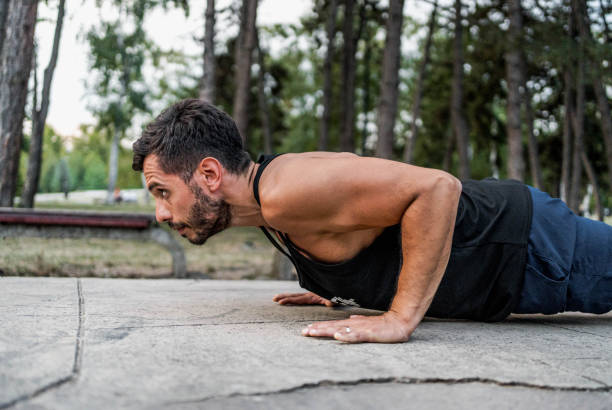 istock Man doing push-ups outdoors 2167433837
