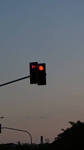 istock traffic light on the road at night 2167435376