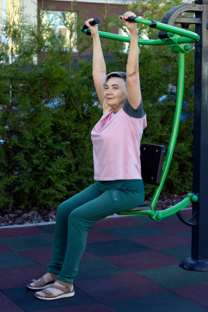 istock Senior woman doing exercises on a street machine. 2167435711