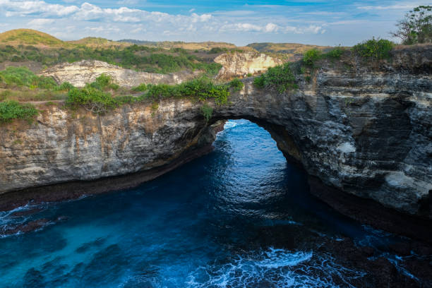 istock Natural Rock Arch Over Blue Waters 2167438606