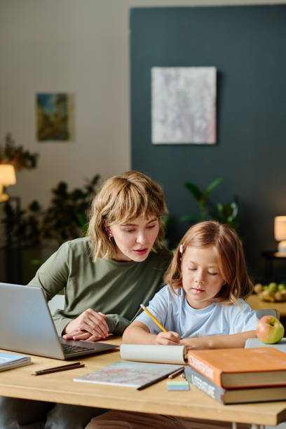 istock Mother and Daughter Studying at Home 2167442314