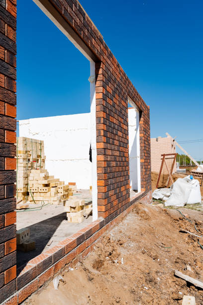 istock Construction site with brick wall under clear sky showing incomplete building structure in progress, showcasing construction and development work in urban setting 2167443563