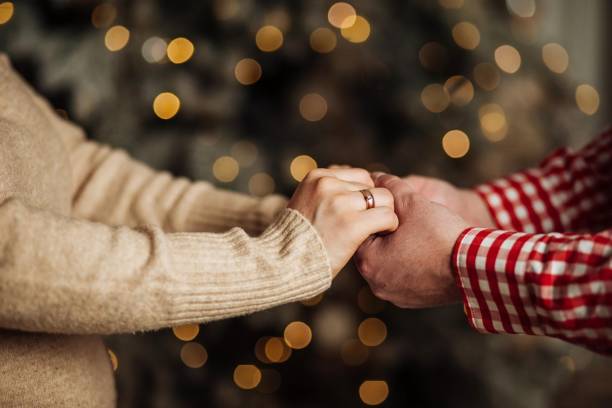 istock Couple hold hands in green field on sunset 2167447495