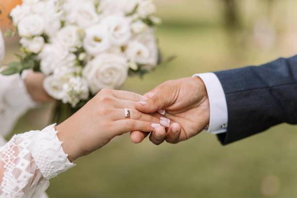 istock Couple hold hands in green field on sunset 2167447528