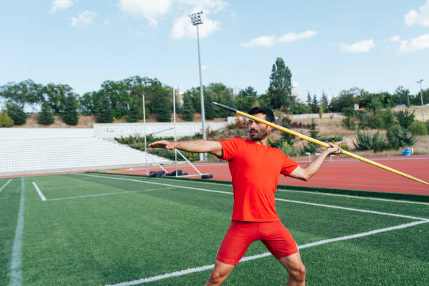 istock An athletic man throws the javelin in the stadium. 2167448133