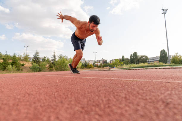 man athlete in a starting position looking determined and focused
