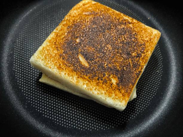 istock Black burnt toast bread on teflon coated pan. Unhealthy. Fail and accident 2167449458