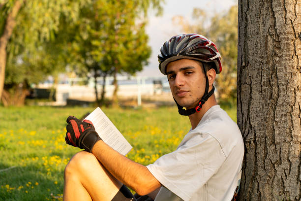 istock Traveling bicycle rider reading a book. 2167451182