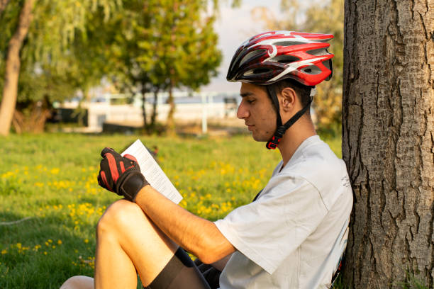 istock Traveling bicycle rider reading a book. 2167451231