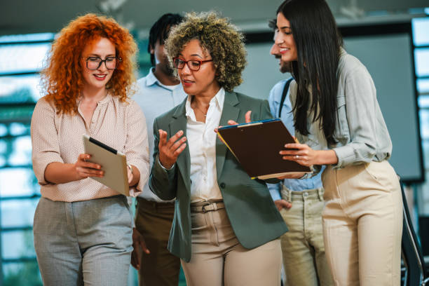 istock Multiracial group of colleagues walking down the hall and talk about work. 2167452485