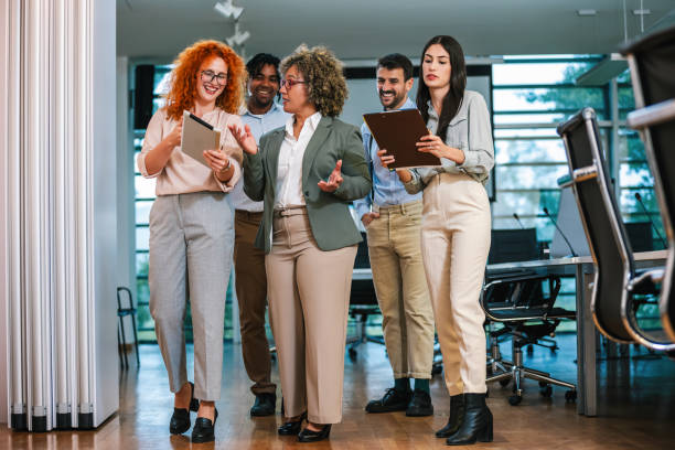 istock Multiracial group of colleagues walking down the hall and talk about work. 2167452572