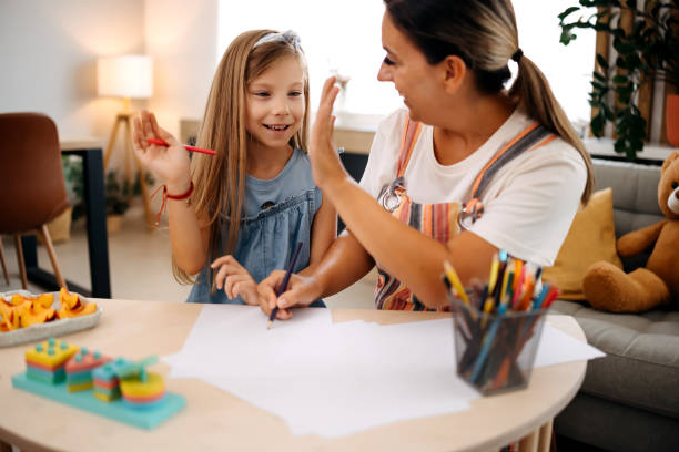 istock Mother helps her daughter with her homework 2167453706