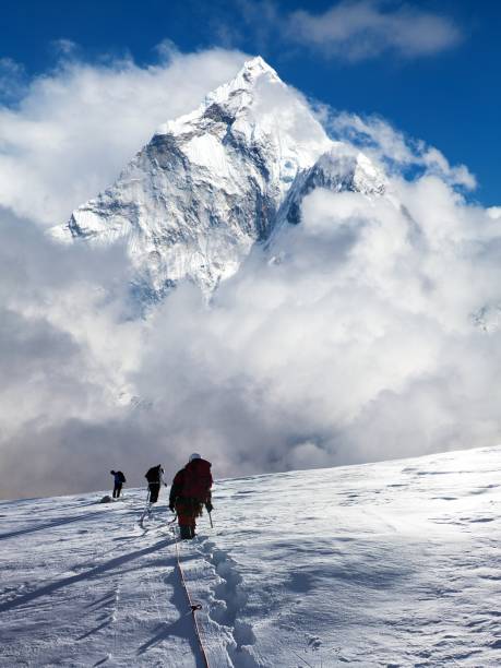 istock montage of three hikers on glacier and mount Ama Dablam 2167459221