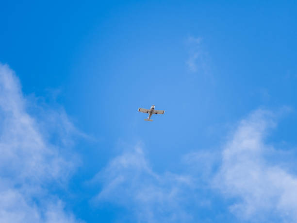 istock Small ultralight airplane with overhead wing and single propeller flying in sunset sky. 2167464071
