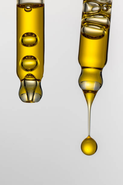 istock Dripping cosmetic serum from pipettes on white background 2167466196