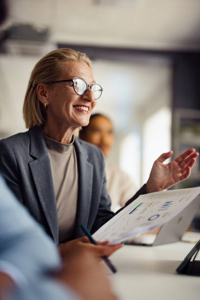 Confident Businesswoman Presenting Data in Office Meeting