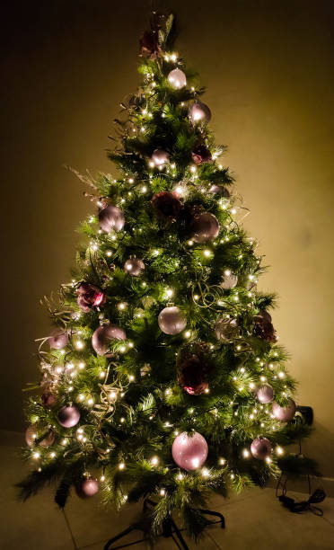 istock Christmas tree lit up and with pink decorations 2167468603