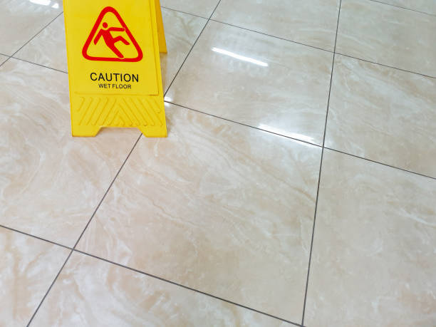 istock Wet floor with caution slippery sign. Incident warning. Office worker safety. 2167468662