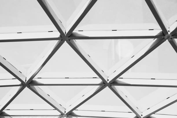 Close-up view of a geometric metal frame structure with intersecting lines and shapes. Black and white architecture pattern, construction, and modern design