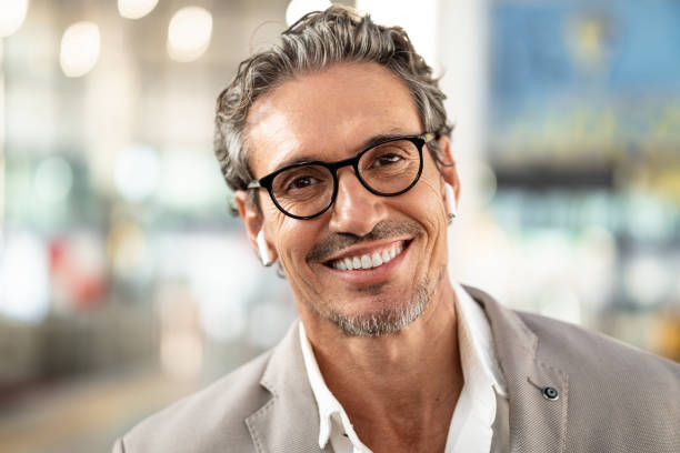 Close-up portrait of a happy mature businessman Close-up portrait of a happy mature businessman in a train station mediterranean ethnicity stock pictures, royalty-free photos & images
