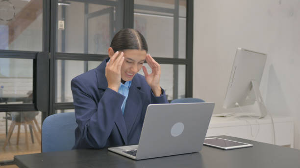 istock Hispanic Businesswoman having Migraine at Work 2167473411