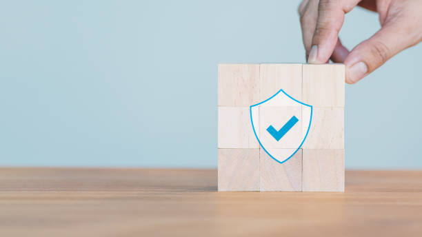 istock Hand put a wooden cube block with identity proof icon for security protection system on wood table. Certified guarantee approval or secure access system concept. Quality assurance of business service. 2167477091