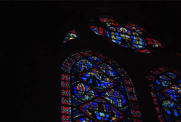 istock Vibrant stained glass windows in dark cathedral interior 2167477737