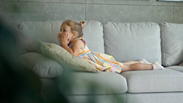 istock Serious Child Playing on the Sofa at Home. 2167480010