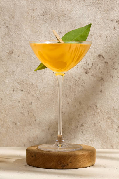 istock Refreshing Tropical Gimlet Cocktail with Lime Garnish in Elegant Glassware on Textured Background 2167486674