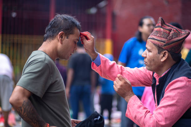 Hindu devotee receive tika from priest during the Janai Purnima festival, also known as Raksha Bandhan at gokarneshwor temple in Kathmandu, Nepal, on  Monday August 19, 2024