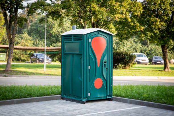 istock Green mobile toilet in the car parking outdoors, a temporary solution 2167494333