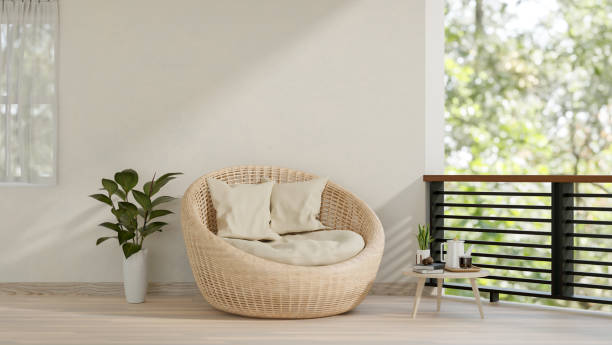 istock A contemporary home balcony relaxation space features a wicker lounge chair with pillows. 2167494989