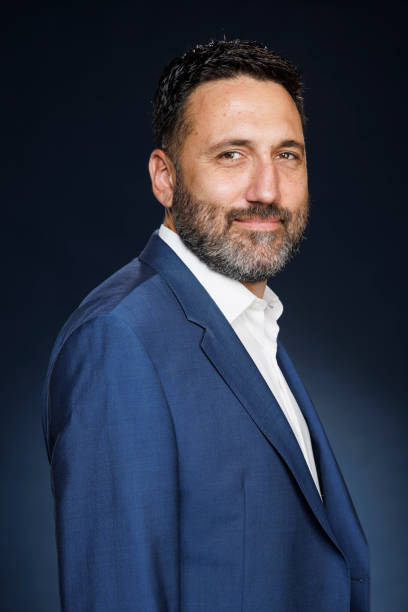 istock Studio portrait handsome man.  Elegance Blue well-dressed  businessman,  Dark blue background. 2167504265