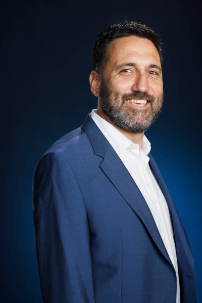 istock Studio portrait handsome man.  Elegance Blue well-dressed  businessman,  Dark blue background. 2167504317