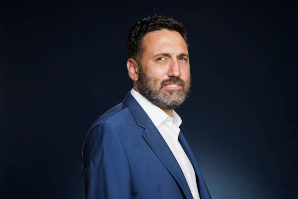 istock Studio portrait handsome man.  Elegance Blue well-dressed  businessman,  Dark blue background. 2167504475