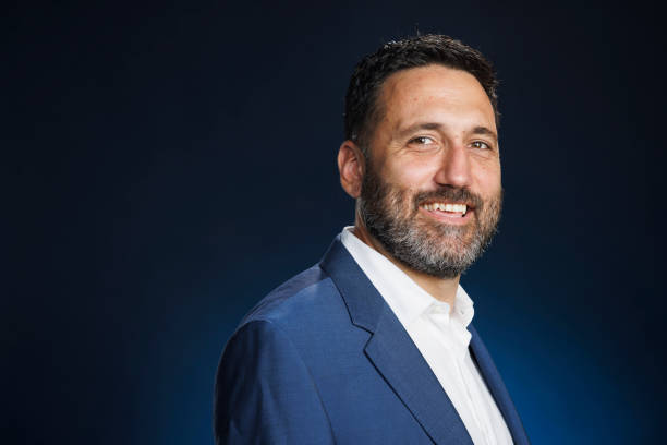 istock Studio portrait handsome man.  Elegance Blue well-dressed  businessman,  Dark blue background. 2167504492