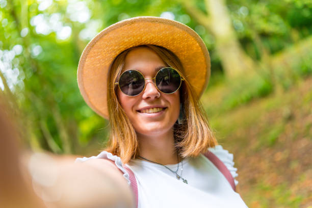 istock Young woman taking a selfie while hiking in the forest 2167506497