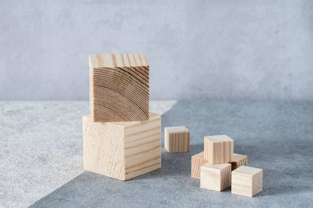 istock Wooden cubes stands on grey-beige background. 2167507170