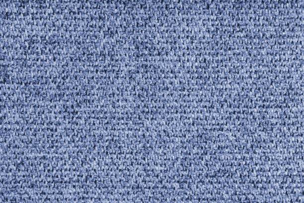Coarse weave texture upholstery blue jacquard fabric. Textile background, furniture textile material, wallpaper, backdrop. Cloth structure close up, macro