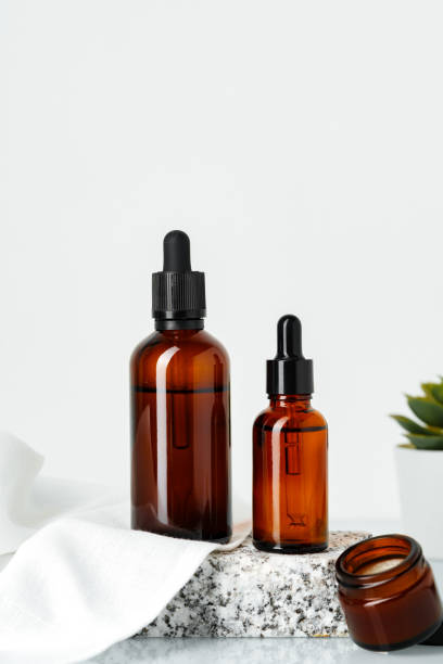 istock Amber Glass Bottles With Dropper Tops Displayed on a Stone Platform 2167509969