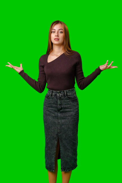 istock Young Woman Gesturing With Open Palms in Front of Green Screen 2167510620
