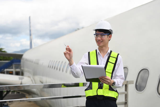 istock Professional aviation engineer with clipboard standing on platform near the aircraft 2167511401