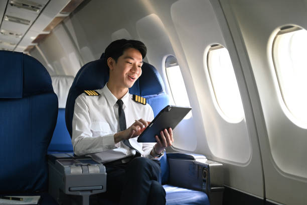istock Smiling pilot checking flight plan or preparing flight procedures in an airplane cabin 2167511402