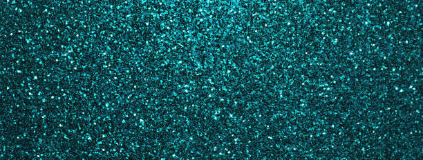 Dark turquoise sparkling background from small sequins, macro. Cyan shiny backdrop with glitter pattern.
