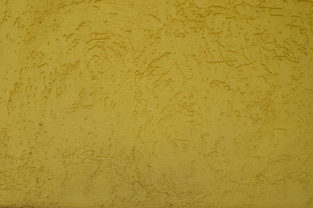 istock Background - yellow wall with stucco worm finish 2167514861