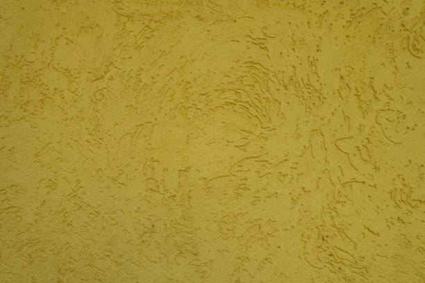 istock Textured surface of yellow wall with stucco worm finish 2167515111