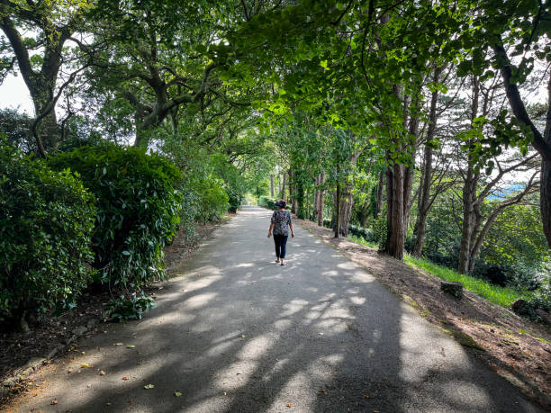 istock Senior Hispanic woman walking through public park 2167515614